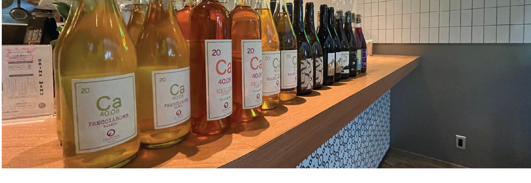 Natural wine bottle lineup on the counter