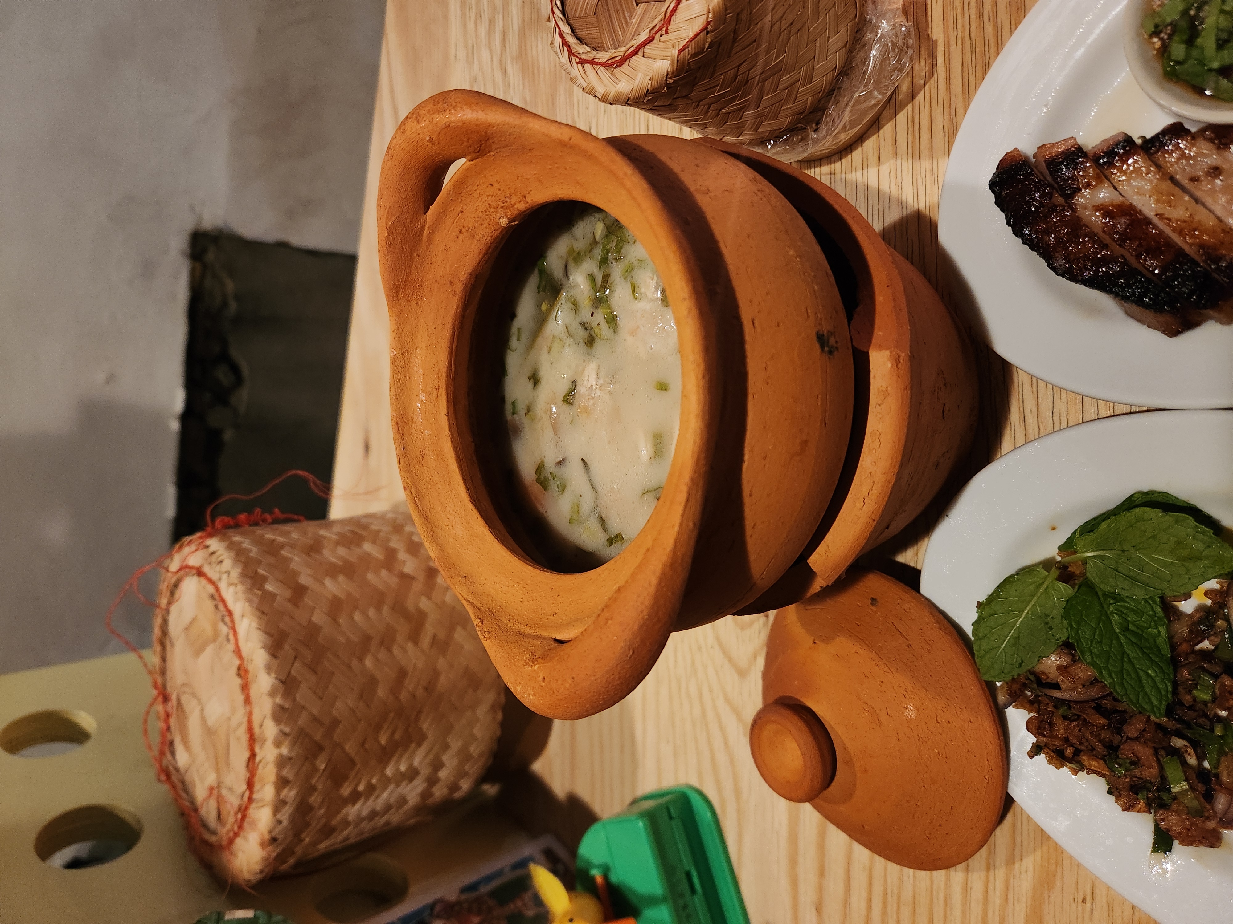 Clay-pot coconut soup served with sticky rice baskets