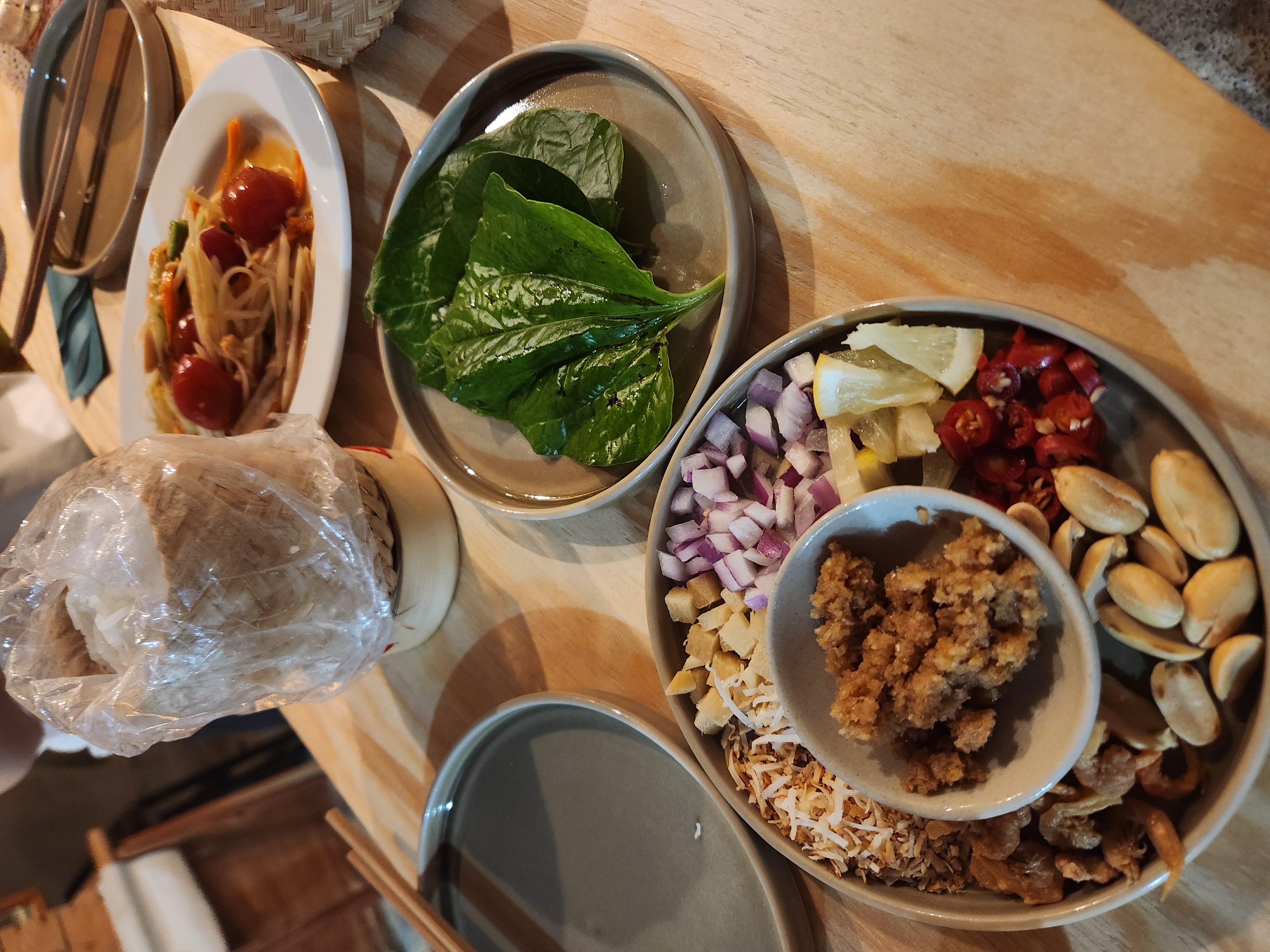 Miang kham platter — betel leaves with coconut, shallot, peanut, chili and lime