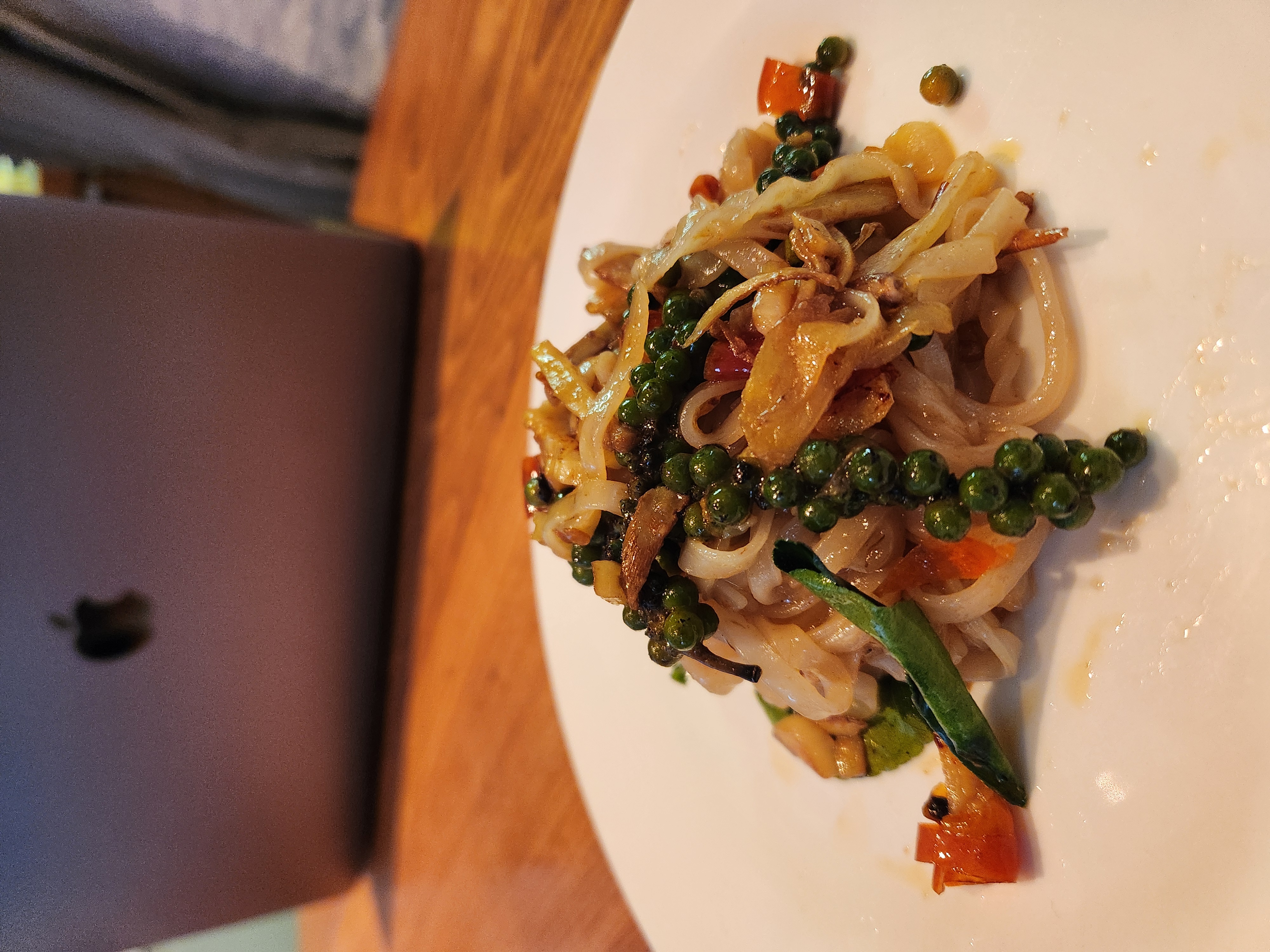 Stir-fried rice noodles tangled with fresh green peppercorn
