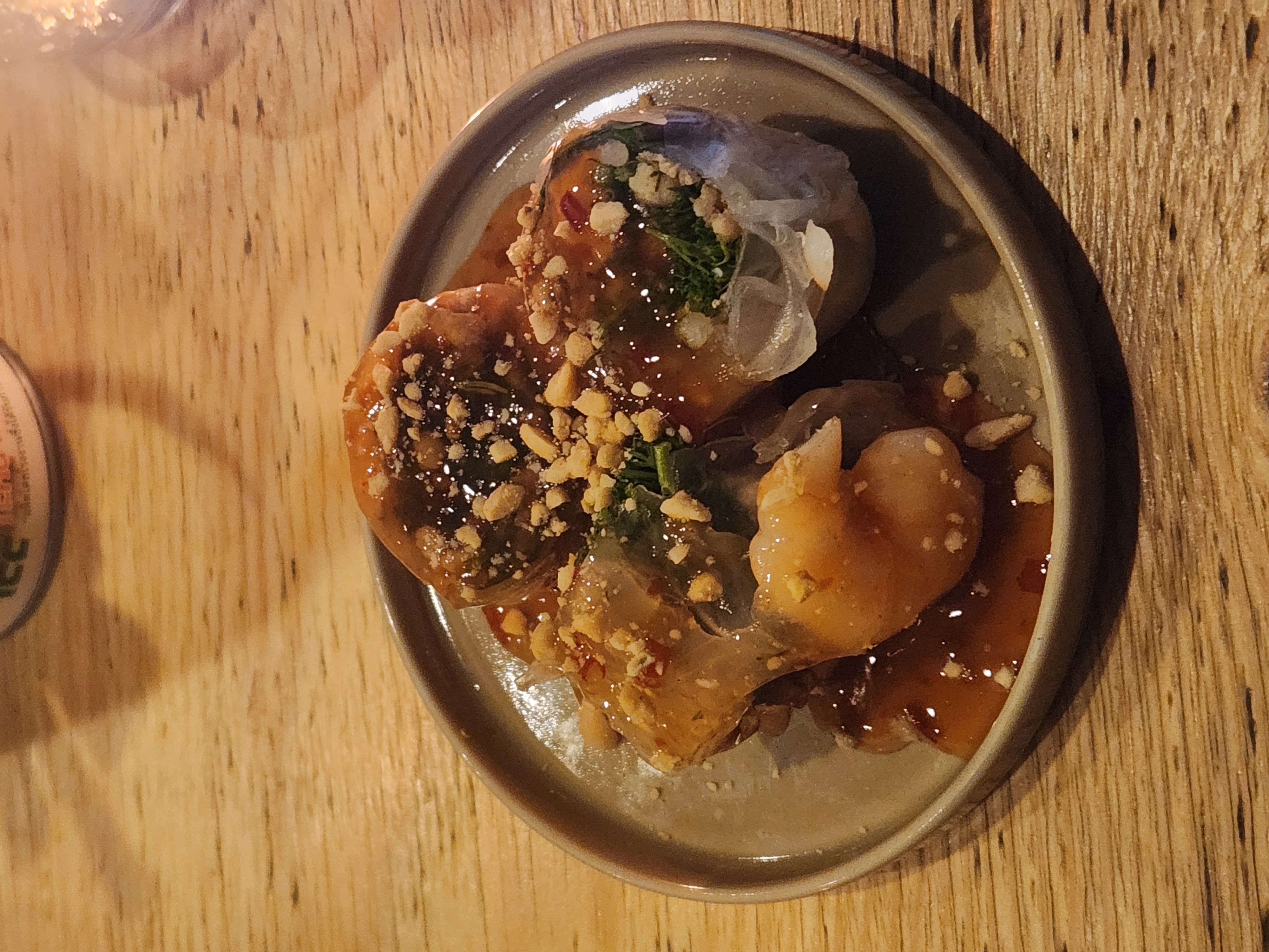 Steamed rice-skin parcels with peanut and tamarind sauce