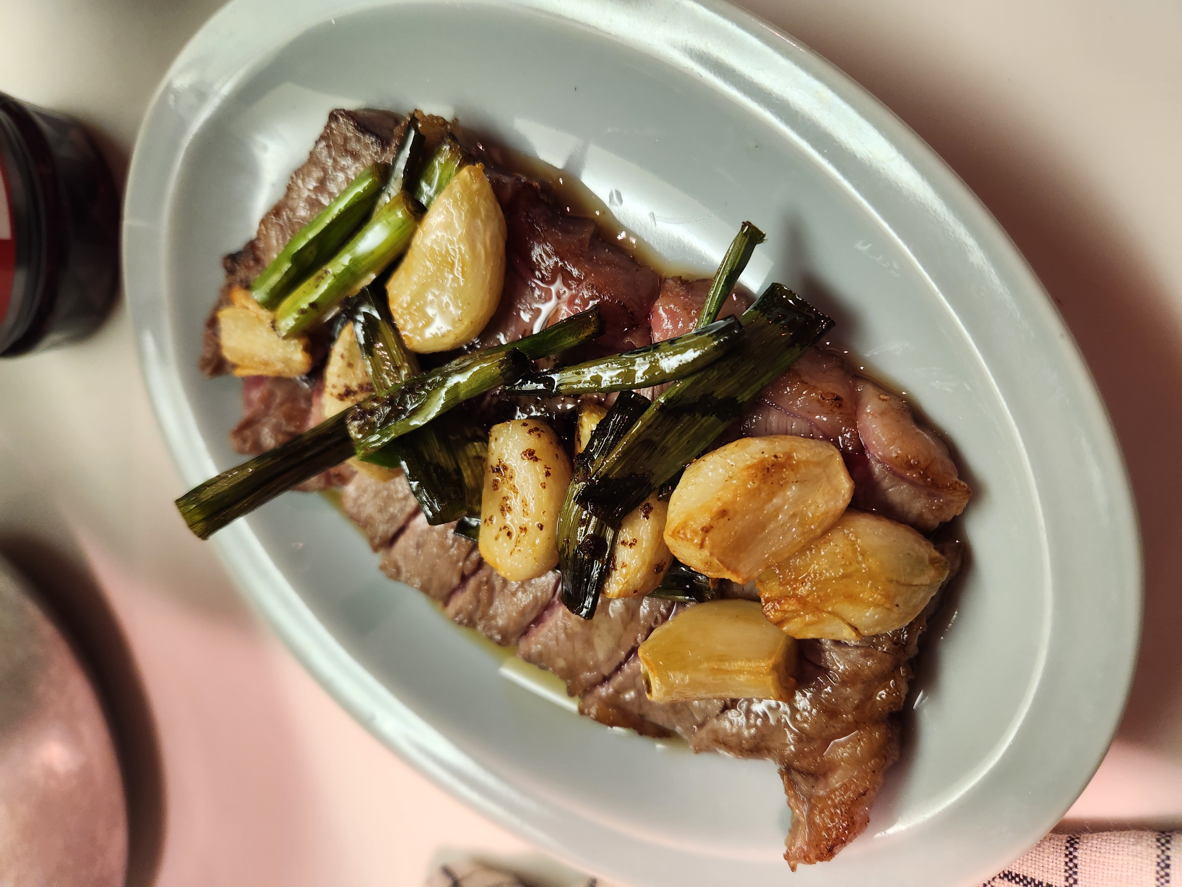 Seared Thai-style beef with grilled garlic and spring onion